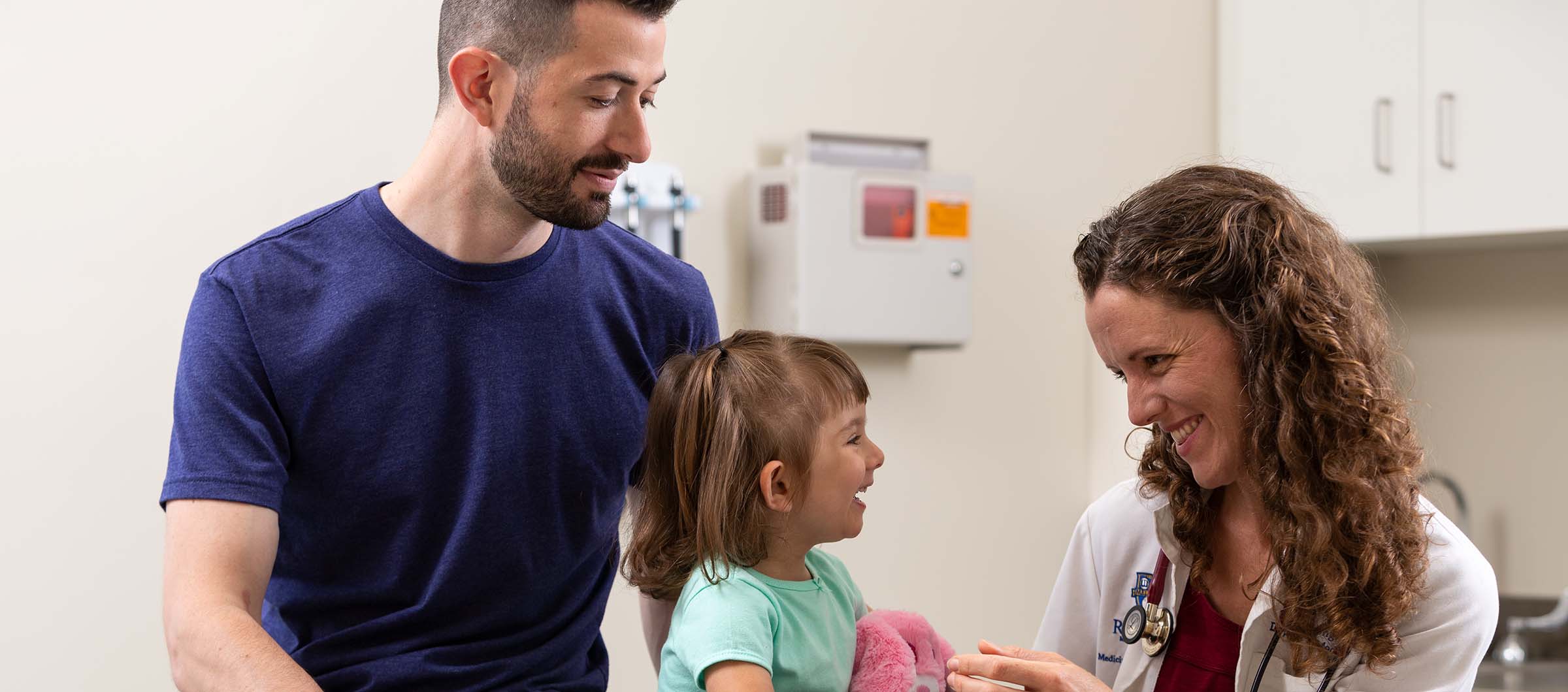Photo of pediatrician with baby and dad